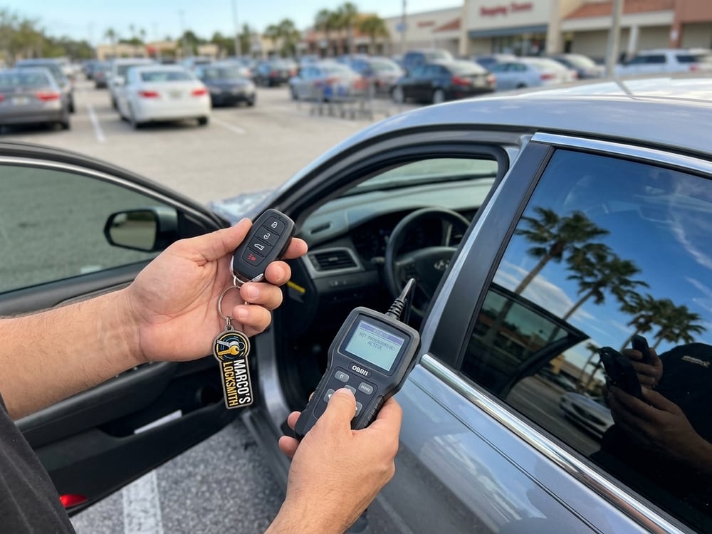 Smart key fob being programmed at a customer's car in a parking lot